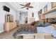 Large main bedroom with light wood floors, tray ceilings, and a built-in vanity and wardrobe at 16410 Ivy Lake Dr, Odessa, FL 33556
