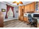 Functional home office featuring built-in cabinets, a granite countertop, and a comfortable workspace at 16410 Ivy Lake Dr, Odessa, FL 33556