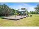 Community playground featuring swings, slide, and play structure under a shaded canopy on a well maintained lawn at 16410 Ivy Lake Dr, Odessa, FL 33556