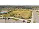 Aerial view of community athletic fields and parking area, perfect for sports and recreation at 16549 Secret Meadow Dr, Odessa, FL 33556