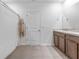 Neutral bathroom featuring a single vanity with wood cabinets and tile flooring at 16549 Secret Meadow Dr, Odessa, FL 33556