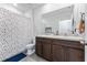 Bathroom with a double sink vanity, tile flooring, and a shower/tub with a colorful curtain at 16549 Secret Meadow Dr, Odessa, FL 33556