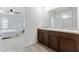 Bathroom vanity with double sinks and large mirror at 16549 Secret Meadow Dr, Odessa, FL 33556