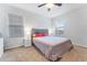 Bedroom with ceiling fan, windows, and carpet at 16549 Secret Meadow Dr, Odessa, FL 33556