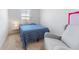 Cozy bedroom with a comfortable armchair and a twin bed next to a window at 16549 Secret Meadow Dr, Odessa, FL 33556