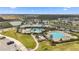 Aerial view of a community center with a swimming pool, seating area, and ample parking at 16549 Secret Meadow Dr, Odessa, FL 33556