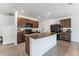 Kitchen with central island with granite countertop, stainless steel sink, and dark brown cabinetry at 16549 Secret Meadow Dr, Odessa, FL 33556