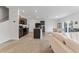Open floor plan showcasing kitchen with island, dark wood cabinets, black appliances, and bar seating at 16549 Secret Meadow Dr, Odessa, FL 33556