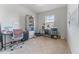 Office space with natural light, dual desk setup, and ample storage shelving at 16549 Secret Meadow Dr, Odessa, FL 33556