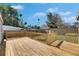 Large wooden back deck with custom wooden railing and a fire pit overlooking the backyard at 1940 N Betty Ln, Clearwater, FL 33755