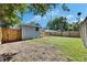 Spacious backyard featuring a deck with a firepit, privacy fence and grassy yard at 1940 N Betty Ln, Clearwater, FL 33755