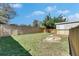 Fenced backyard featuring a shed, a wooden deck, and a fire pit at 1940 N Betty Ln, Clearwater, FL 33755