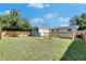 View of the home's backyard featuring a firepit and fenced yard at 1940 N Betty Ln, Clearwater, FL 33755
