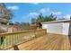 Spacious backyard featuring a wooden deck with fire pit, privacy fence and a shed at 1940 N Betty Ln, Clearwater, FL 33755