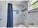 Updated bathroom featuring marble-look tile, updated fixtures, and a shower with blue accents at 1940 N Betty Ln, Clearwater, FL 33755