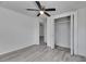 Bedroom featuring closet with folding doors, ceiling fan, and light gray flooring at 1940 N Betty Ln, Clearwater, FL 33755