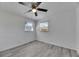 Bright bedroom with ceiling fan, light gray flooring, and two windows with natural light at 1940 N Betty Ln, Clearwater, FL 33755