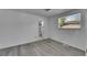 A cozy bedroom featuring wood-look floors and a view to an ensuite bathroom, providing comfort and convenience at 1940 N Betty Ln, Clearwater, FL 33755