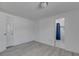 A simple bedroom with wood-look floors and access to an adjacent bathroom at 1940 N Betty Ln, Clearwater, FL 33755