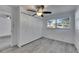 Bedroom featuring closet, ceiling fan, light gray flooring and window providing natural light at 1940 N Betty Ln, Clearwater, FL 33755