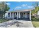 Inviting covered front porch, featuring a seating area and well-maintained outdoor space for relaxation at 1940 N Betty Ln, Clearwater, FL 33755