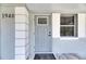 Close-up of the front door with decorative trim, house number '1940,' and a stylish welcome mat at 1940 N Betty Ln, Clearwater, FL 33755