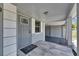 Well-lit front entrance with a stylish door and porch, creating a welcoming atmosphere for residents and guests at 1940 N Betty Ln, Clearwater, FL 33755