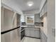 Modern kitchen featuring stainless steel appliances, gray cabinets, and stylish backsplash at 1940 N Betty Ln, Clearwater, FL 33755