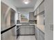 Bright kitchen featuring stainless steel appliances, granite countertops, and a double sink at 1940 N Betty Ln, Clearwater, FL 33755