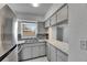 Well-lit kitchen featuring granite countertops, stainless steel appliances, and tiled backsplash at 1940 N Betty Ln, Clearwater, FL 33755