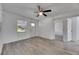 Inviting living room featuring wood-look flooring, a ceiling fan, and a bright window at 1940 N Betty Ln, Clearwater, FL 33755