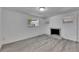 Bright living room featuring wood-look floors, a decorative fireplace, and plenty of natural light from the windows at 1940 N Betty Ln, Clearwater, FL 33755