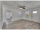 Spacious living area boasting wood-look floors, natural light, and a ceiling fan at 1940 N Betty Ln, Clearwater, FL 33755