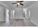 Open-concept living room with modern flooring, access to other rooms, and a ceiling fan at 1940 N Betty Ln, Clearwater, FL 33755