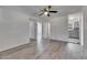 Open living area showcasing wood-look flooring, a ceiling fan, and access to other rooms at 1940 N Betty Ln, Clearwater, FL 33755