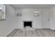 Living room with gray flooring, windows, fireplace, and door to the outside at 1940 N Betty Ln, Clearwater, FL 33755