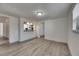 Open living area with view of modern kitchen and new gray plank flooring at 1940 N Betty Ln, Clearwater, FL 33755