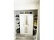 Functional closet with mirror doors and shelving, providing practical storage solutions and wood flooring at 19651 Gulf Blvd # A11, Indian Shores, FL 33785