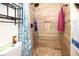 Well-lit bathroom showcasing a tiled shower, niche shelving, and modern fixtures at 204 Amana Ave, Brandon, FL 33510