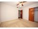 Simple bedroom with a ceiling fan, closet, neutral walls, and carpeted flooring at 204 Amana Ave, Brandon, FL 33510