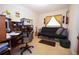 Cozy bedroom featuring a desk, futon, guitar, and natural light from the window at 204 Amana Ave, Brandon, FL 33510
