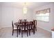 Bright dining room featuring a chandelier, a window with blinds, and a dining set for six at 204 Amana Ave, Brandon, FL 33510