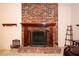 Living room features a fireplace with decorative brickwork and a wooden mantel at 204 Amana Ave, Brandon, FL 33510