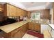 Kitchen featuring granite countertops, a mosaic backsplash, and wood cabinetry at 204 Amana Ave, Brandon, FL 33510