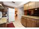 Kitchen featuring granite countertops, a mosaic backsplash, white appliances, and wood cabinetry at 204 Amana Ave, Brandon, FL 33510