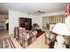 Inviting living room with patterned sofas, wood entertainment center, and open access to the dining area at 204 Amana Ave, Brandon, FL 33510