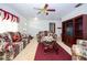 Cozy living room featuring floral furniture, ceiling fan, and a classic entertainment center at 204 Amana Ave, Brandon, FL 33510