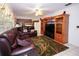 Cozy living room with leather sofas, a ceiling fan, built-in shelving, and a TV at 204 Amana Ave, Brandon, FL 33510
