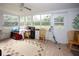 Bright sunroom with multiple windows, tiled flooring, and access to the outdoors at 204 Amana Ave, Brandon, FL 33510