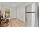 Bright dining room has sleek wood-look floors, a ceiling fan, and modern refrigerator at 226 Benes Rd, Brooksville, FL 34604